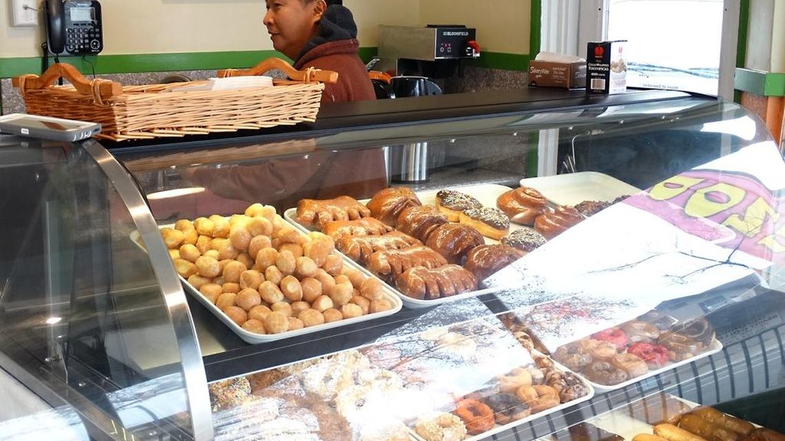 Friends Sam Kang and T.J. Nguyen, both of Merced, are partners in Vegan Donuts Gelato, which opened about five weeks ago on Needham Street in downtown Modesto, Calif. Their plant-based products include no diary products or eggs. Here, Kang works behind the doughnut case Tuesday (01-17-17) while talking with customers.