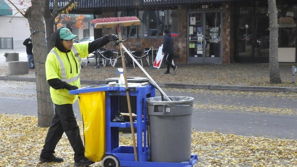 A crew of six “downtown ambassadors” is employed by the nonprofit Downtown Modesto Partnership, working six days a week to clean up and assist visitors and business and property owners. Here, Austin Nino collects trash along Tenth Street Plaza on Wednesday, Dec. 14.