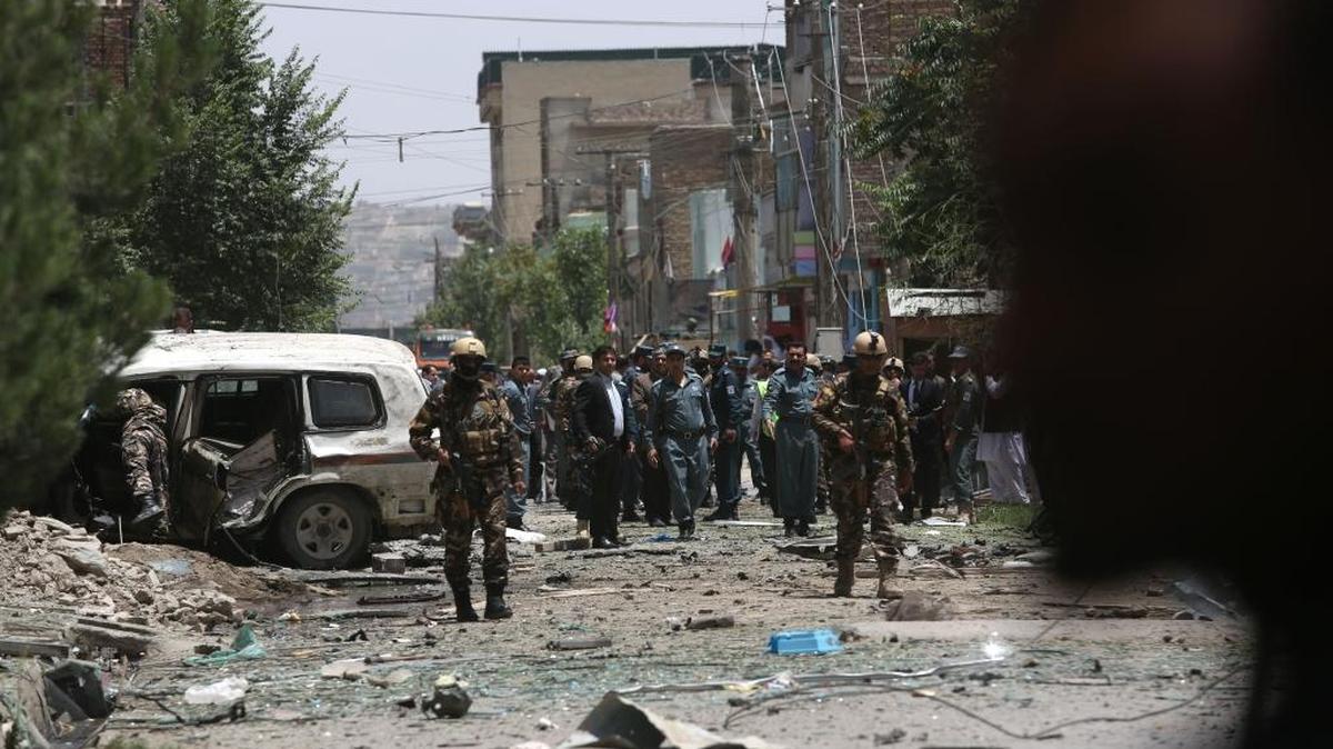 
Afghan security personal inspect the site of a suicide car bomber that targeted a NATO convoy in Kabul, Afghanistan on July 7. 
