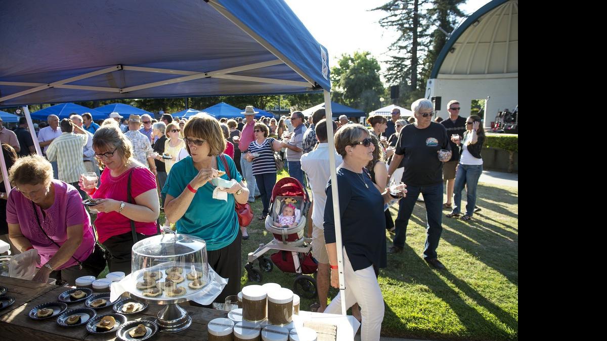 
People sample food and drinks during the Night at the Bowl fundraiser at Mancini Bowl on Tuesday. The fundraiser supports MoBand and Modesto’s Parks, Recreation and Neighborhoods Department.
