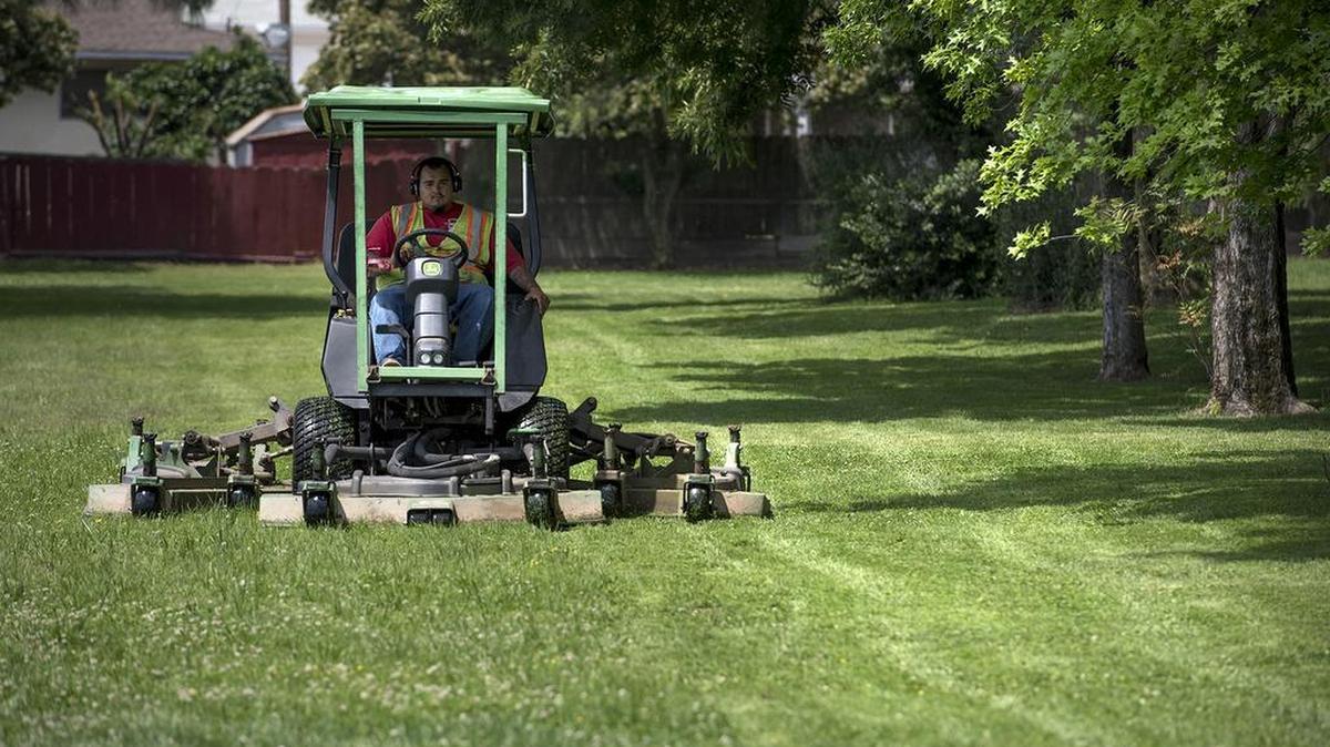 City of Oakdale groundskeeper Alex Hough cuts the grass at Gilbert Park in Oakdale on Monday, May 9, 2016. California will consider letting urban water agencies decide for themselves how much they each need to save so they do not run out of water if the drought continues.
