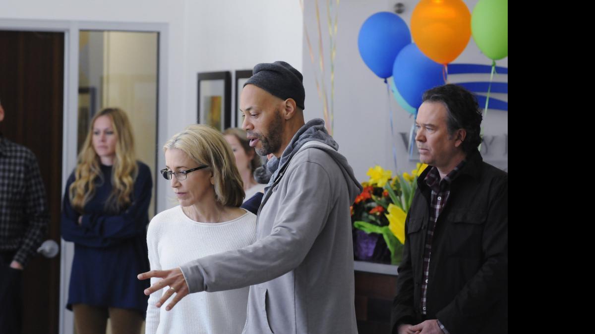 
John Ridley, center, directs Felicity Huffman, left, and Timothy Hutton in “American Crime.”
