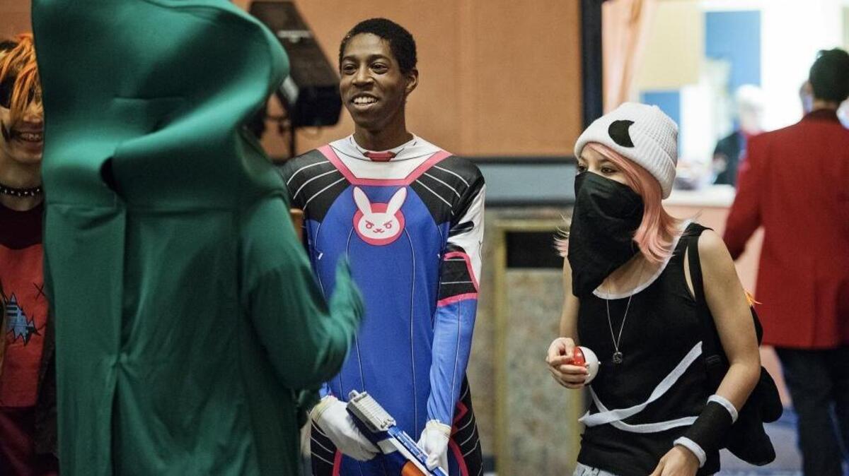 Kyle Hopkins dressed as D.va from Overwatch, middle, and Isabell Hernandes, dressed as a character from Pokemon, talk with friends during the 2017 Cosies at the West Side Theatre in Newman, Calif., on Saturday, Jan. 7, 2017. Both are from Newman.