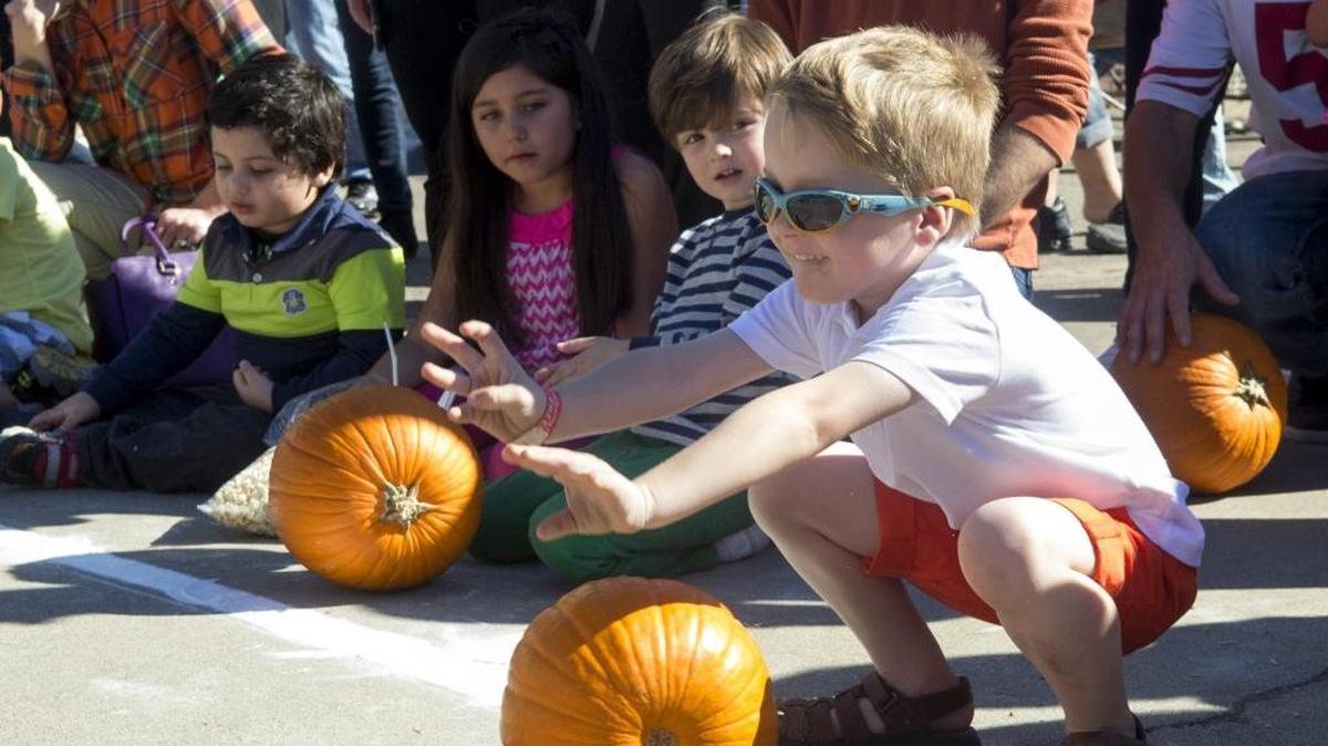 Jasper Davis, age 5, rolls a pumpkin in the age 5 and under division during the 52nd annual Knights Ferry Pumpkin Roll in Knights Ferry on Sunday, Nov. 1, 2015.
