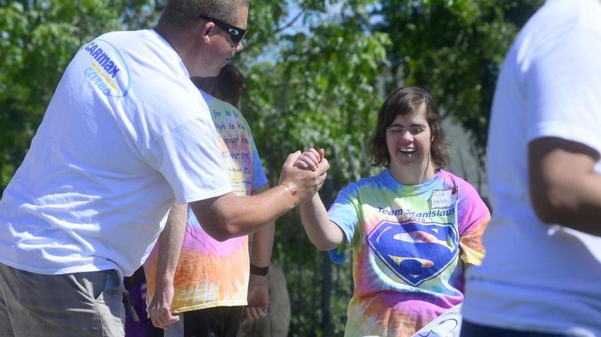 Athlete Julie Nelch, right, is congratulated by volunteer Francis Derollo after competing in the softball throw during the Special Olympics of Northern California Stanislaus Games at John F. Kennedy School in Ceres, Calif., on Saturday, April 23, 2016.