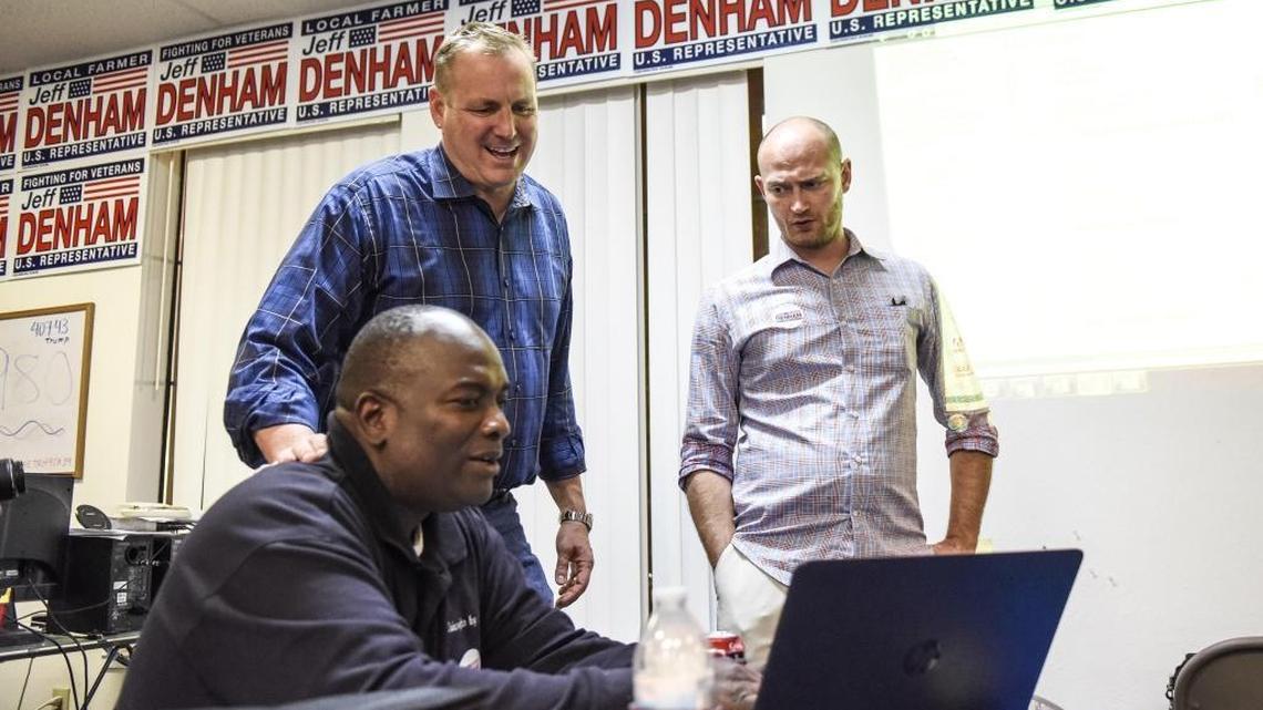 U.S. Rep. Jeff Denham looks over early election results with Jeremiah Williams, left, and Republican Party field director John Freeman, right, at Denham’s campaign headquarters in Modesto on Tuesday.