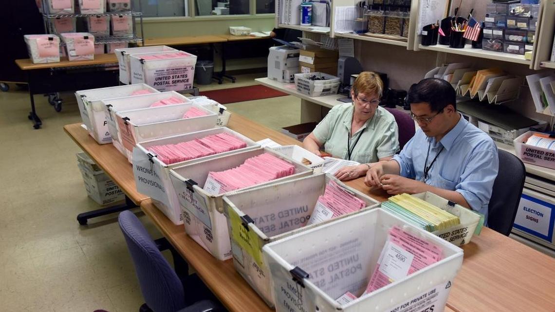 Election staff Mary Nickles and Alex Chang work with ballots Wednesday (06-22-16) at the Stanislaus County Registrar of Voters office in downtown Modesto.