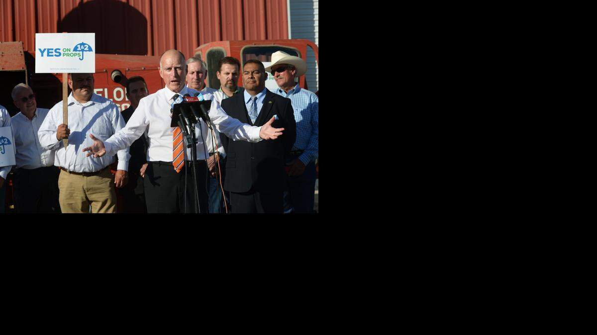 
Gov. Jerry Brown is surrounded by local politicians as he visits the Jake Wenger farm to urge “yes” votes for Propositions 1 and 2 in Modesto on Wednesday.
