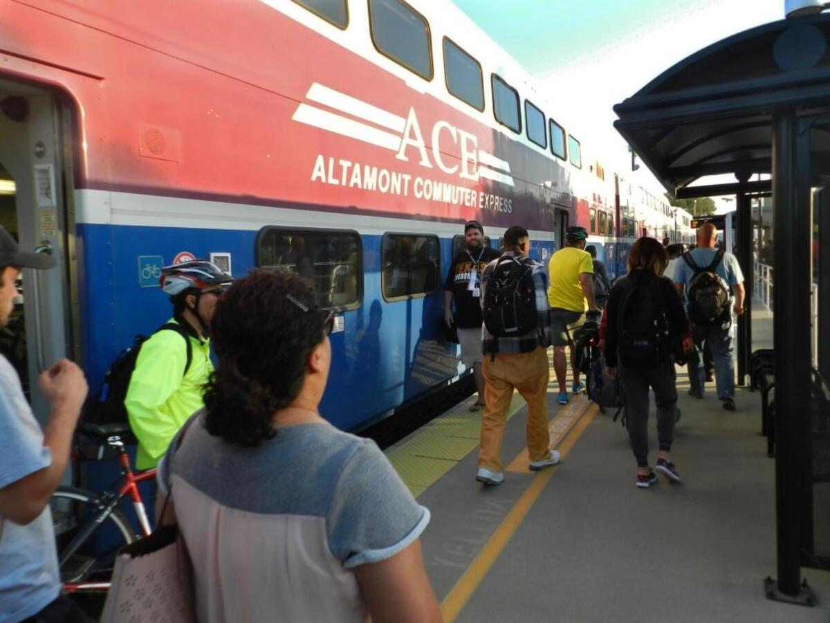 Riders disembark from an Altamont Corridor Express train at a station serving Lathrop and Manteca in September 2017.