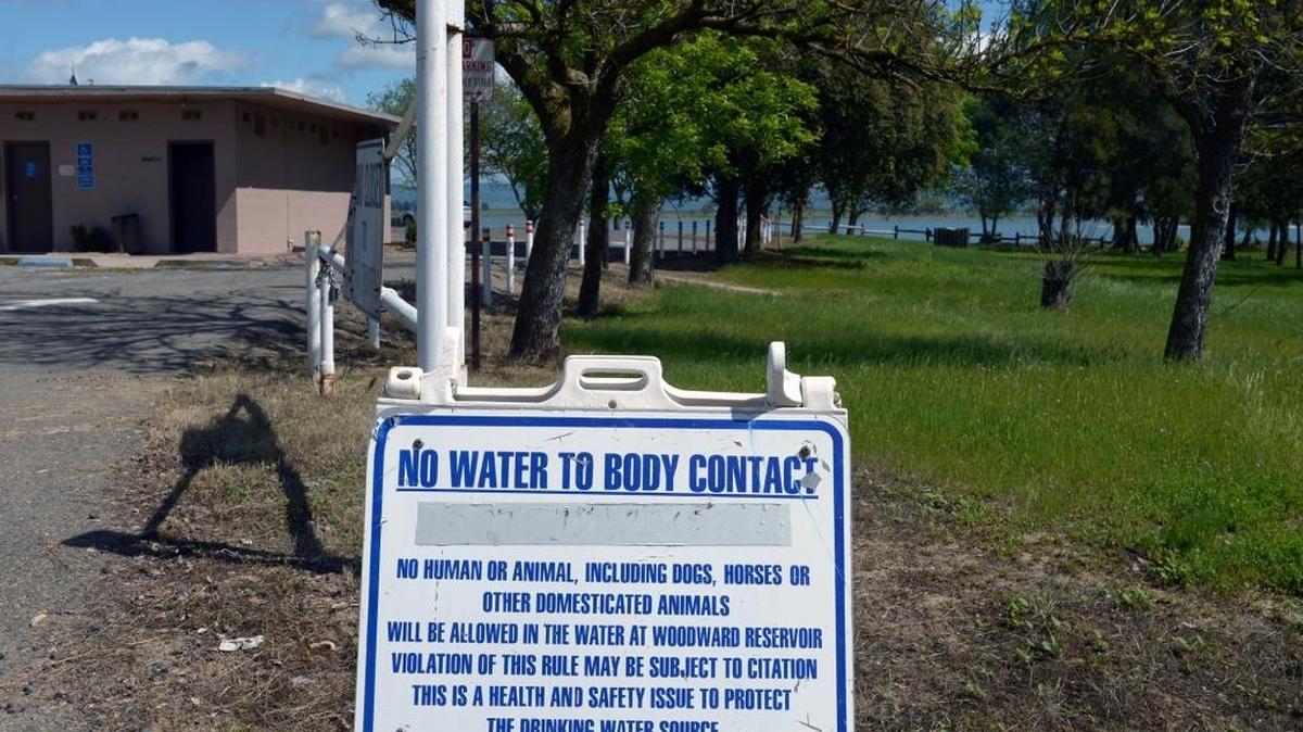 A sign warns people not to enter the water to protect the drinking water at Woodward Reservoir near Oakdale, Calif. on Tuesday afternoon (03-22-16).