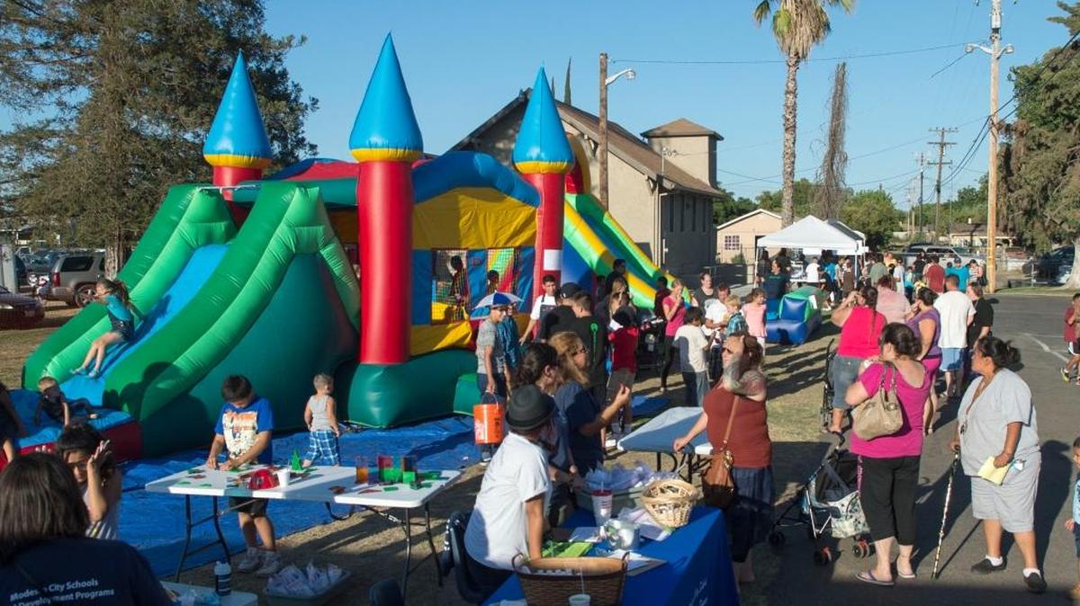 Kids enjoy bounce houses and other kid-friendly activities at the Family Fun Night at Apostolic Jubilee Center in Modesto on July 24, 2015.