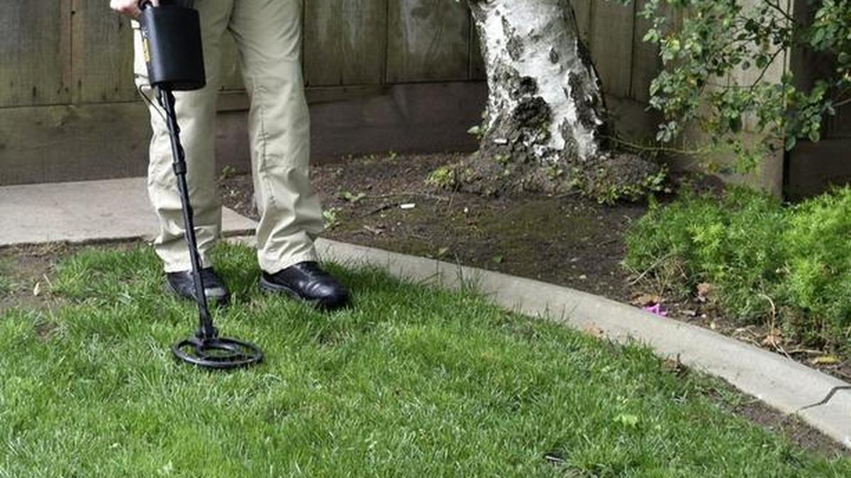 Police are investigating a homicide that occurred early Tuesday on the 600 block of East Union Avenue in Modesto. Detective Sean Dodge uses a metal detector to search for casings in the lawn of the home in front of which Andre Penn’s body was found.