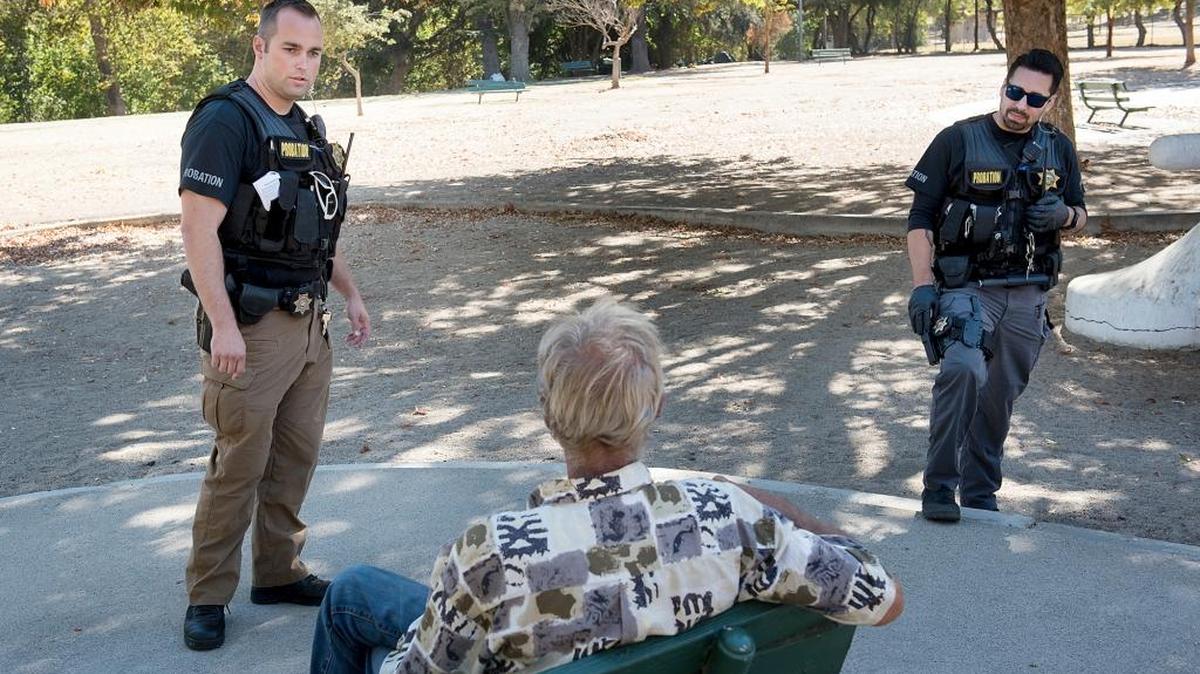 
Stanislaus County probation deputies John Bettencourt, left, and James Gallagher talk with a homeless man in Beard Brook Park on Friday, Oct. 2, 2015.
