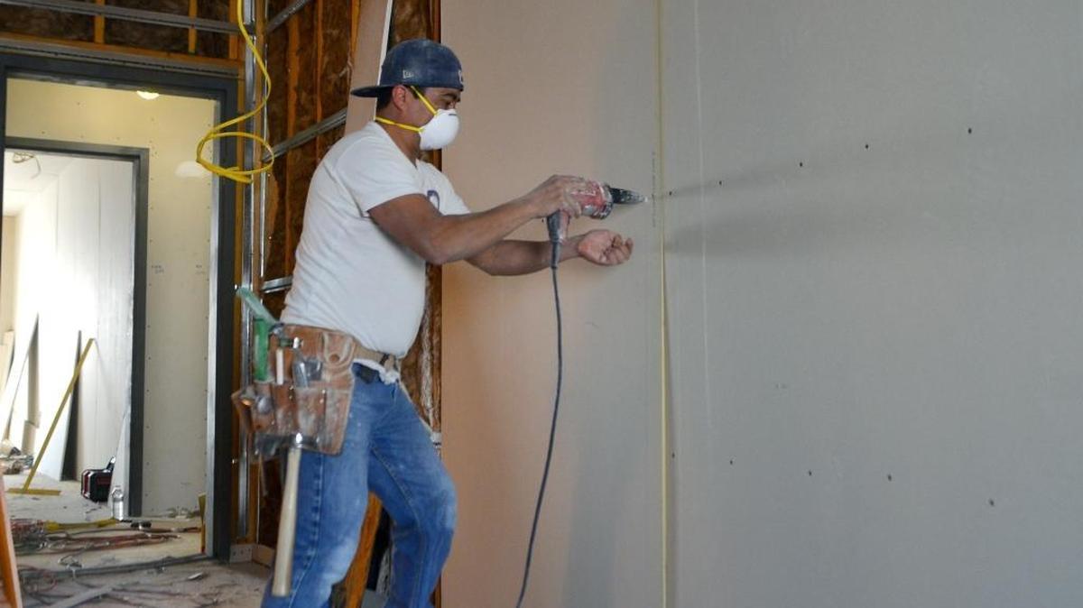 Razio Marcos Hernandez screws in wallboard at the Hampton Inn construction site in Turlock on March 18, 2016. Stanislaus County saw total growth of 600 jobs in February over the prior month, most of them in the leisure and hospitality industry, which grew by 500 jobs.