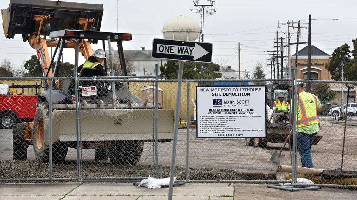 Work crews spread gravel Wednesday morning January 10, 2018 at the site of the new Modesto Courthouse on H street between Ninth and 10th streets in downtown Modesto, Calif.