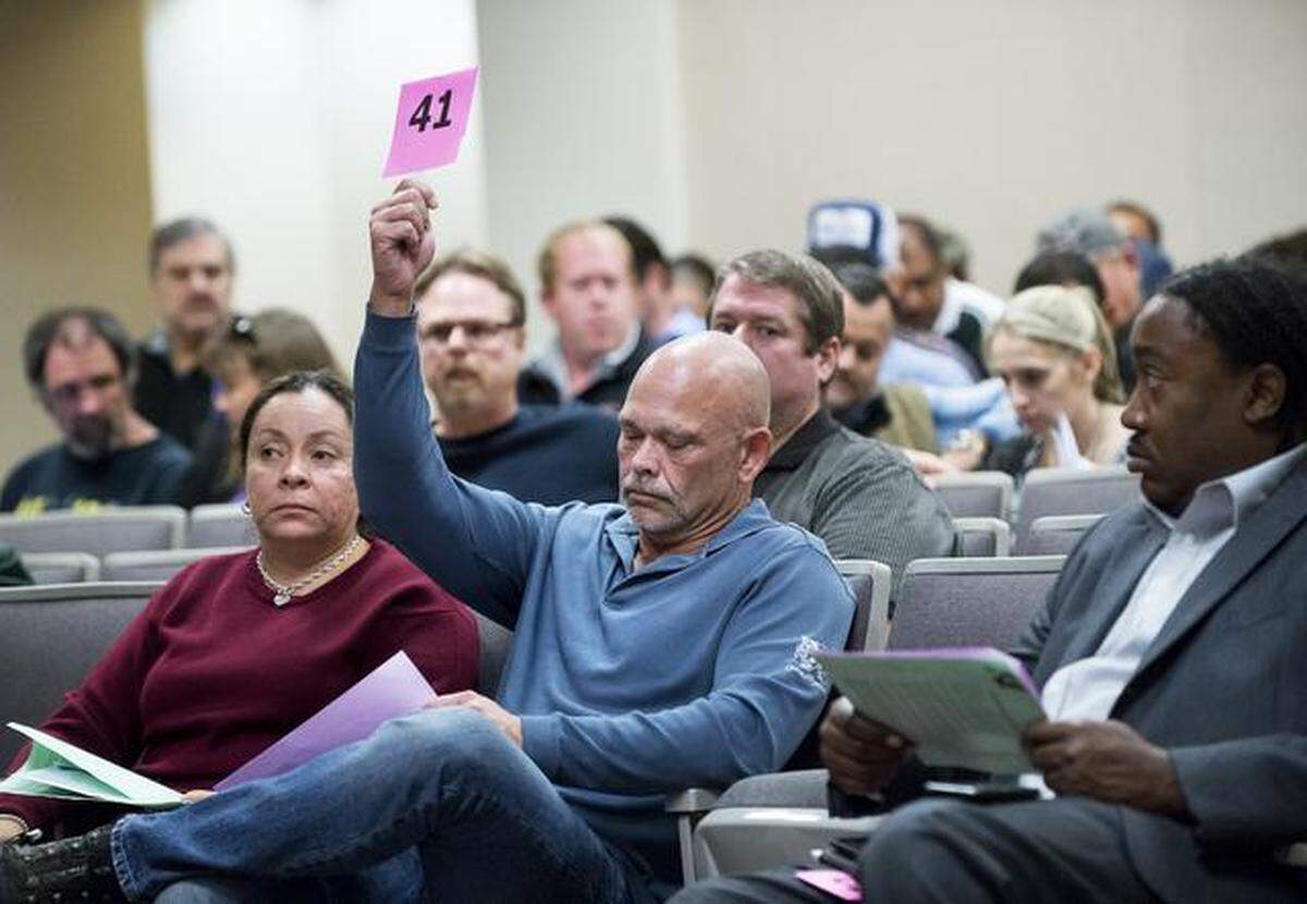In this November 2014 file photo, Charles Smith, right, and Carmen Kearney from World International LLC make a bid on some property in Diablo Grande in west Patterson during the Stanislaus County tax collector’s delinquent tax sale property auction in Modesto.