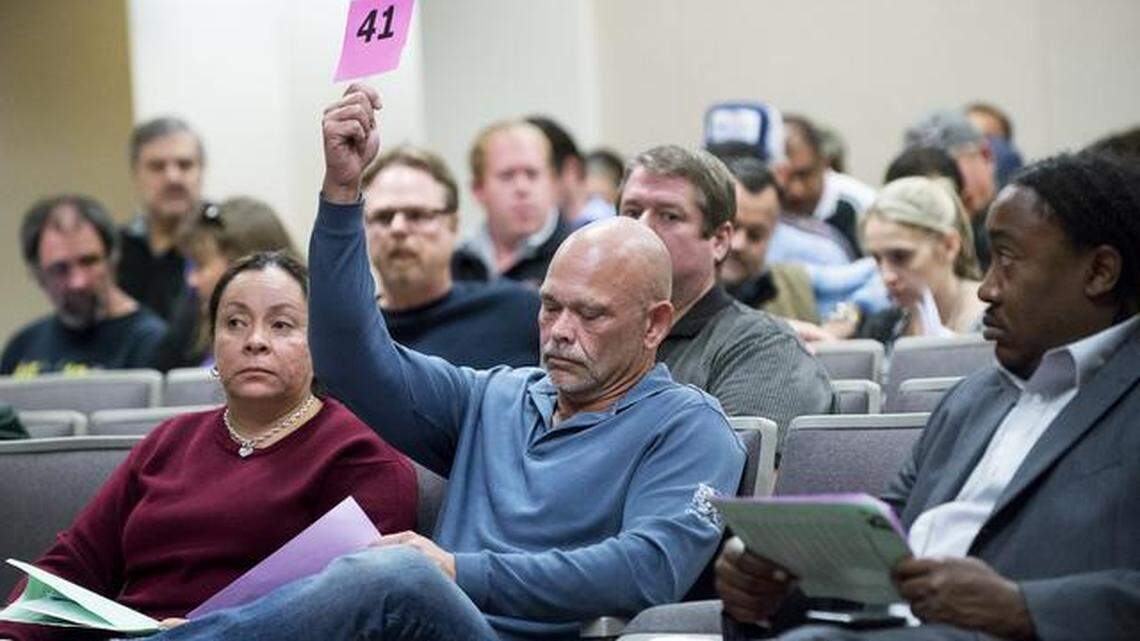 
Charles Smith, right, and Carmen Kearney from World International LLC make a bid on some property in Diablo Grande in west Patterson during the Stanislaus County tax collector’s delinquent tax sale property auction in Modesto on Tuesday.
