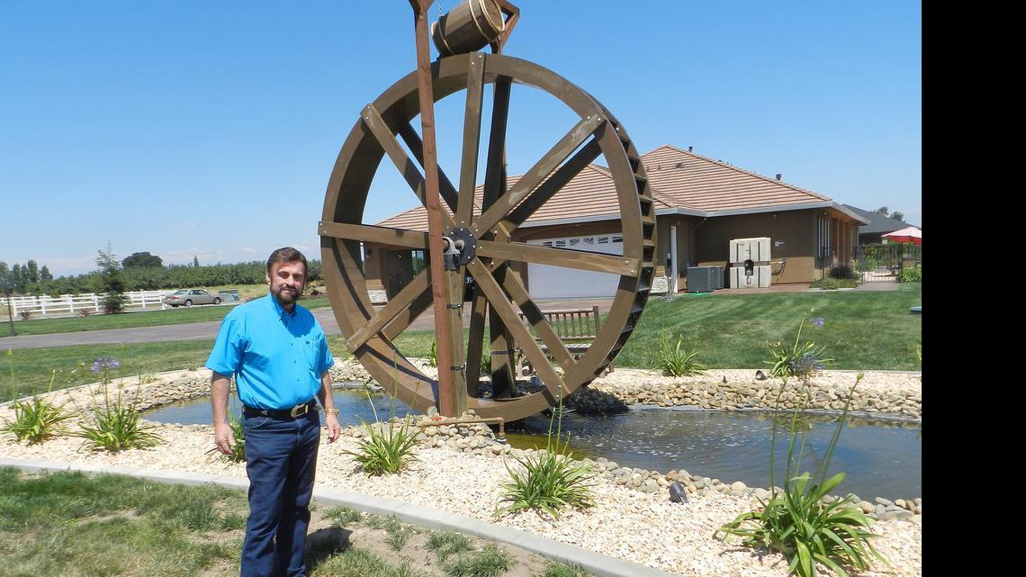
David Busby doubts the 2-acre lawn around his home outside Riverbank will survive the county’s two-days-a-week watering restrictions. He does not irrigate with the waterwheel; it’s just for decoration, he said.
