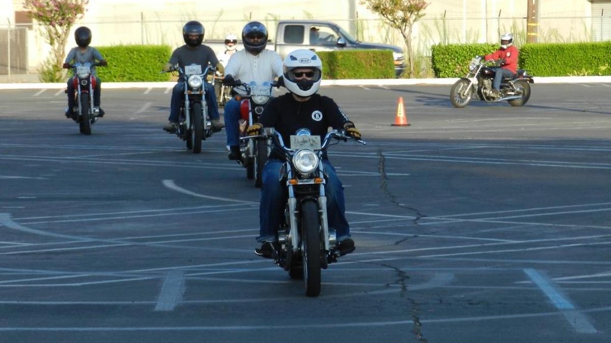 
Modesto Junior College student Elizabeth Hudson leads a line of motorcyclists at the California Motorcycle Safety Program class in a parking lot of the Modesto Junior College East Campus on Aug. 1.
