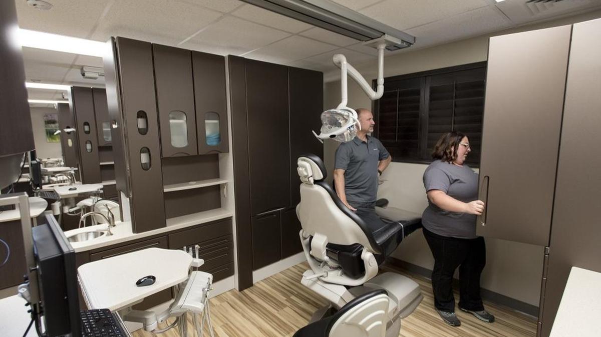 Melissa Kuchan and Stuart Kamstra look at a dental station during an open house at the Golden Valley Health Centers dental clinic at Hanshaw Middle School in Modesto, Calif., on Monday, June 20, 2016.
