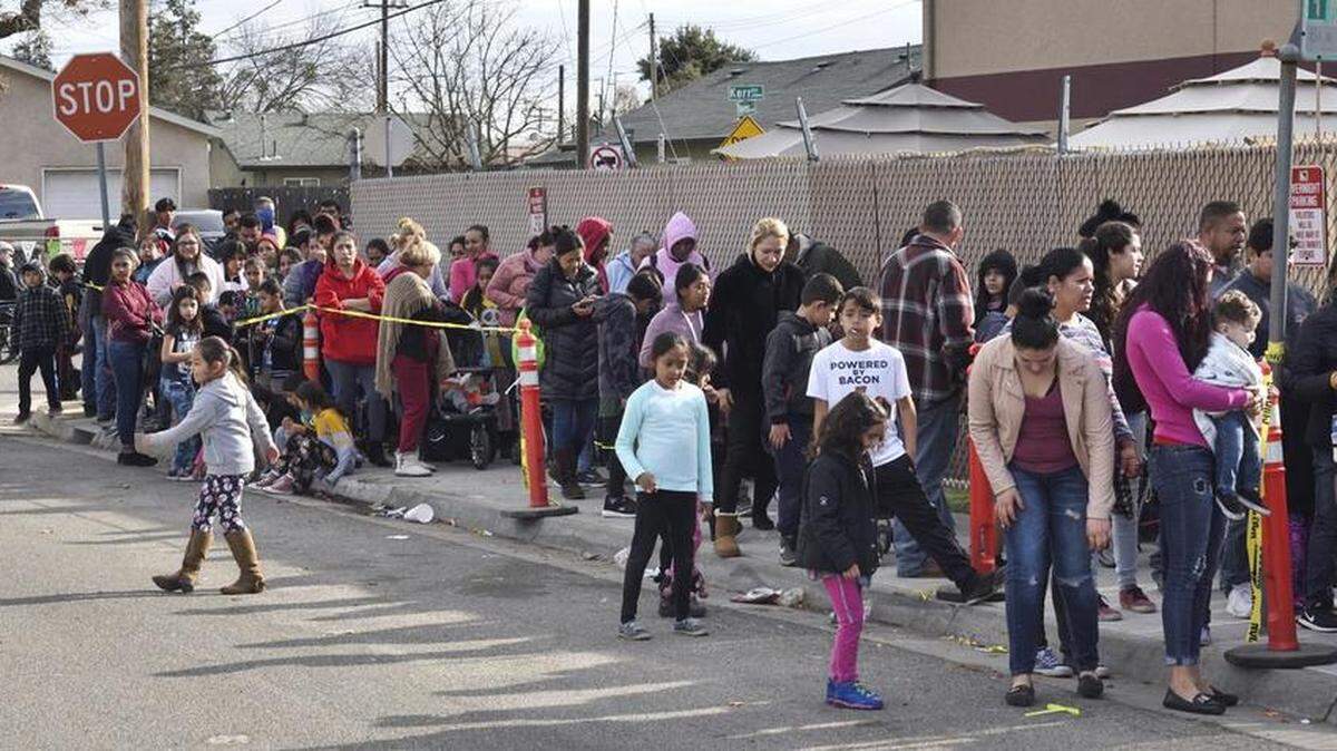 A line of over 2000 people waited for the Happy Birthday Jesus Party at Modesto Gospel Mission Sunday Dec. 23, 2018.