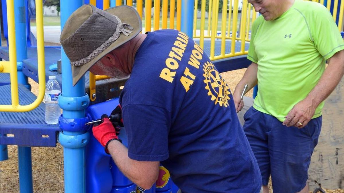 Modesto Sunrise Rotary President Chris Currie, left, and Jon Burgi work on repairing playground equipment during a park cleanup by the Modesto Sunrise Rotary Club at Garrison Park in Modesto on Saturday, June 4, 2016.