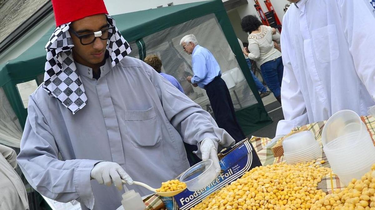 John Hanna scoops up Egyptian beans during the Egyptian Festival at St. Mark Coptic Orthodox Church in Ripon on Saturday, Oct. 15, 2016.