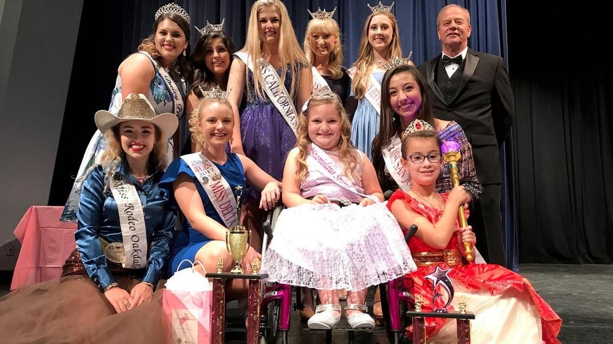 Pictured are Smith (center front) and Reyes (right front) surrounded by visiting regional royalty and Richard O’Brien, board president of the Society for Disabilities (back right).