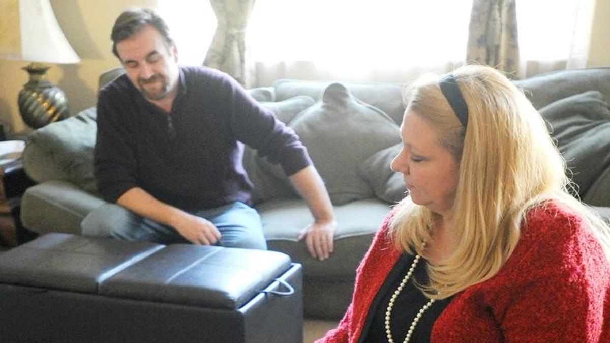 In January 2013, Patterson Councilwoman Sheree Lustgarten files away images depicting a life of domestic violence from her ex-husband, while her new husband, Jeff, sits with her in the living room of their Patterson home.
