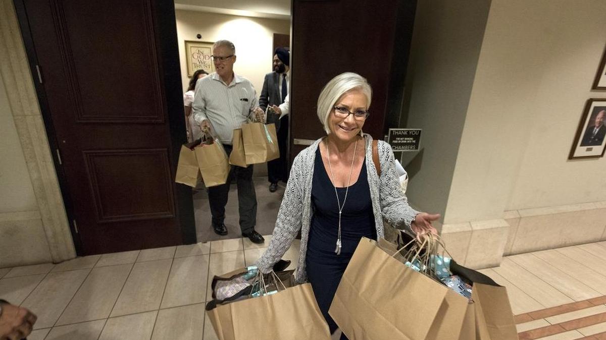 Modesto Pregnancy Center Executive Director Chrissy Aguiar leaves the City Council chambers with donated baby clothes during the Modesto City Council meeting in Modesto on Tuesday. Five charities from the Modesto area received new and gently used baby clothing from the Second Chance Week program.