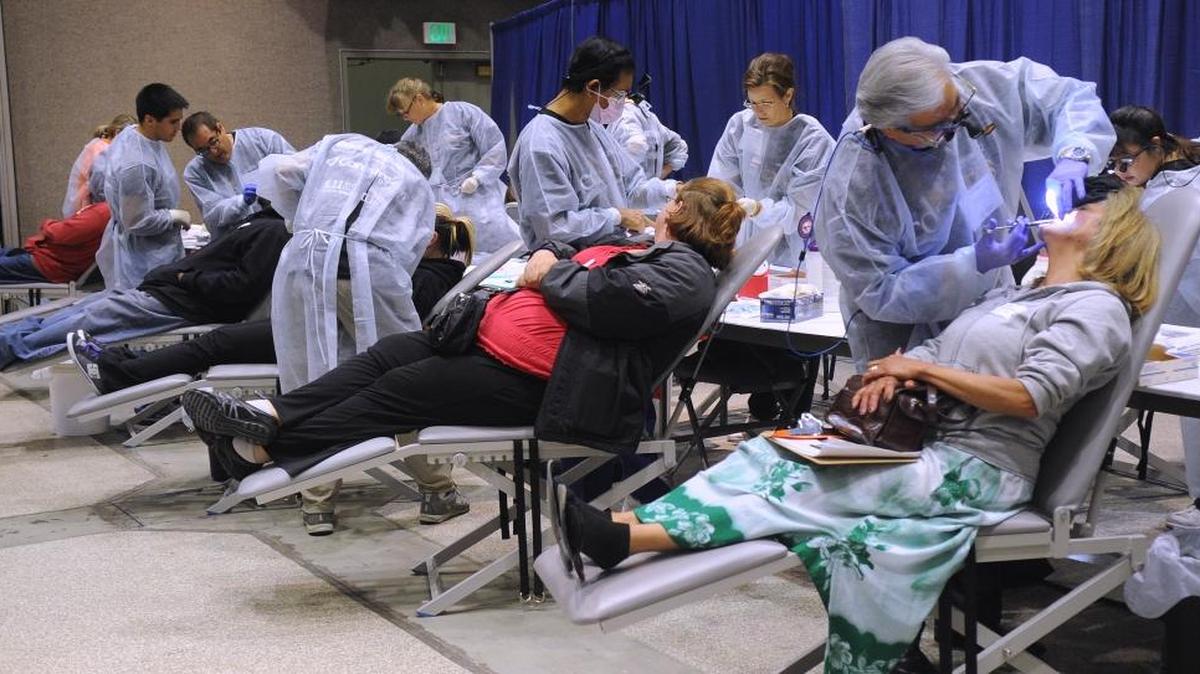 Dental patients receive numbing shots before work is done. The two-day free dental clinic was held at Modesto Centre Plaza in 2012.