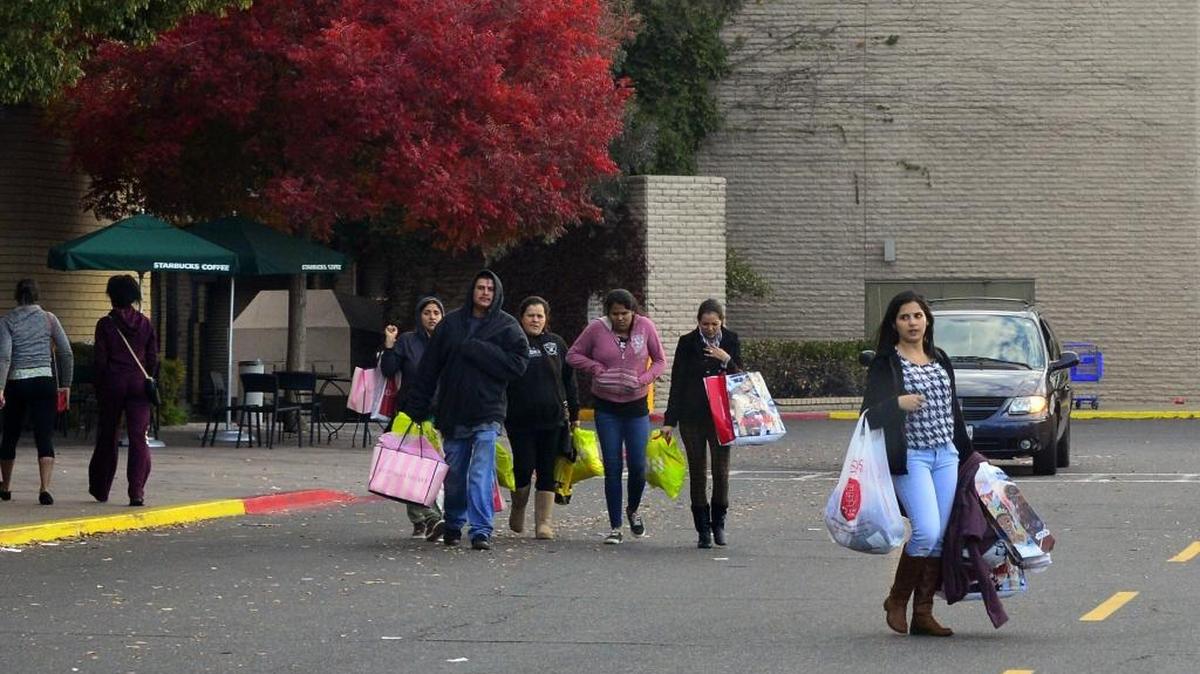 Shoppers leave the Vintage Faire Mall during black Friday in Modesto California on November 27, 2015
