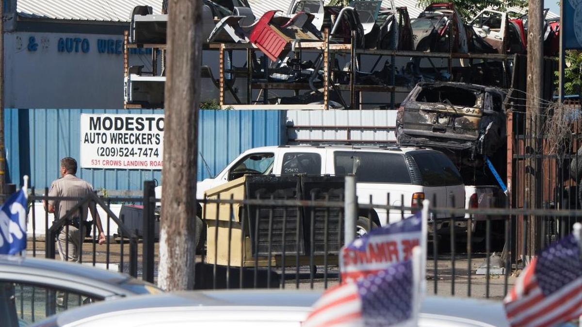 The patrol car of Stanislaus County Sheriff Deputy and a Community Service officer sits on top of something where it burned after a accident killing them both Saturday May13th, 2017 in a car accident on Crows Landing Rd just south of 7th Street in Modesto CA.