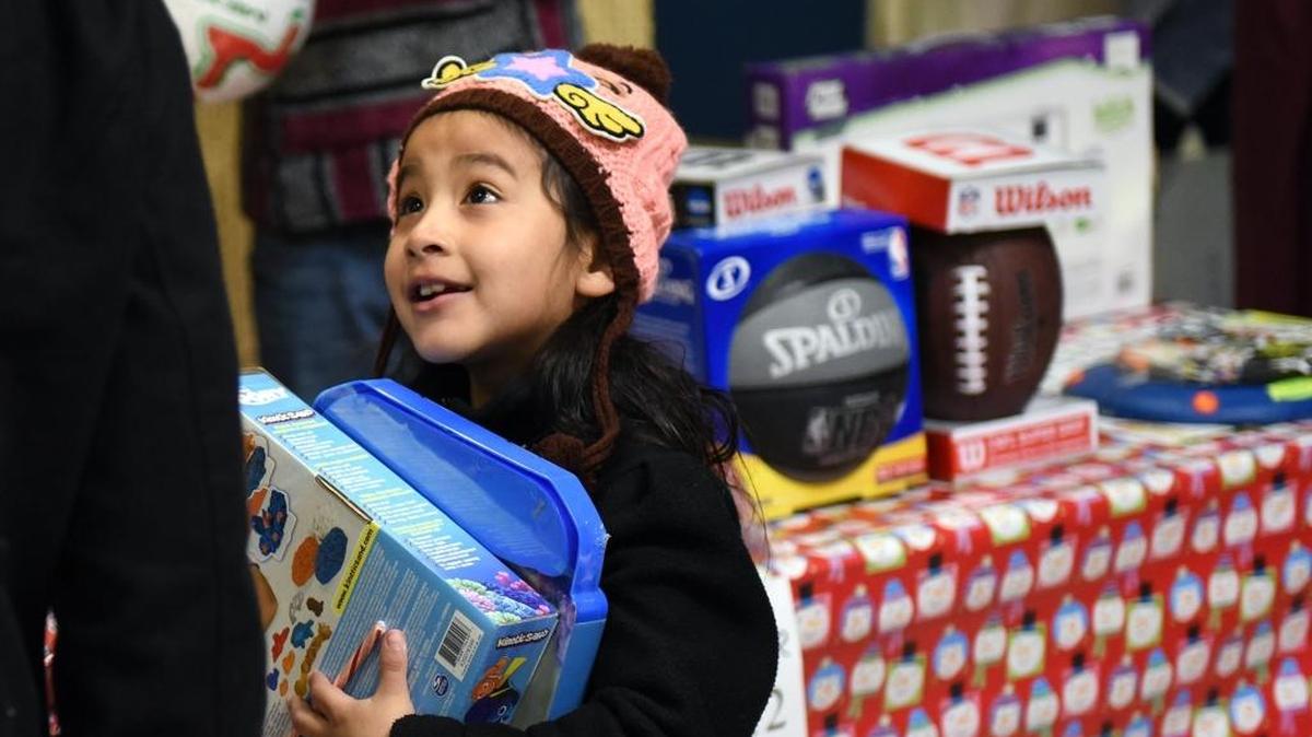 Six year old Juana Godino is happy with her presents Friday afternoon (12-23-16) at the Modesto Gospel Mission's Happy Birthday Jesus party in Modesto, Calif.