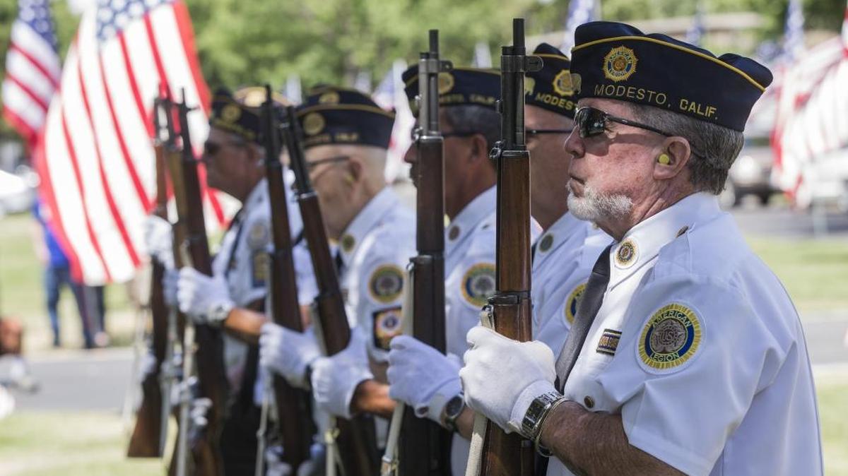 Members of American Legion Post 74 stand at attention prior to the 21-gun salute during the Acacia Memorial Park Memorial Day ceremony in 2017.