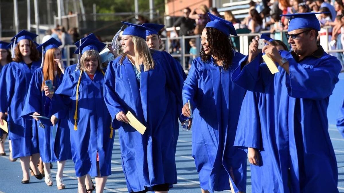 Graduates enter the stadium as Modesto Junior College holds its 94th commencement ceremony Friday, April 29, 2016, in the east campus stadium in Modesto, Calif.