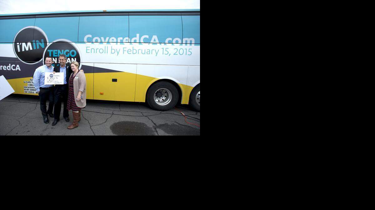 
Peter V. Lee, center, head of the state’s health insurance exchange, poses for pictures in Modesto on Wednesday with Drew Kyler of Covered California and Kate Trompetter of the Center for Human Services. Lee was in Modesto to promote open enrollment for the Affordable Care Act.
