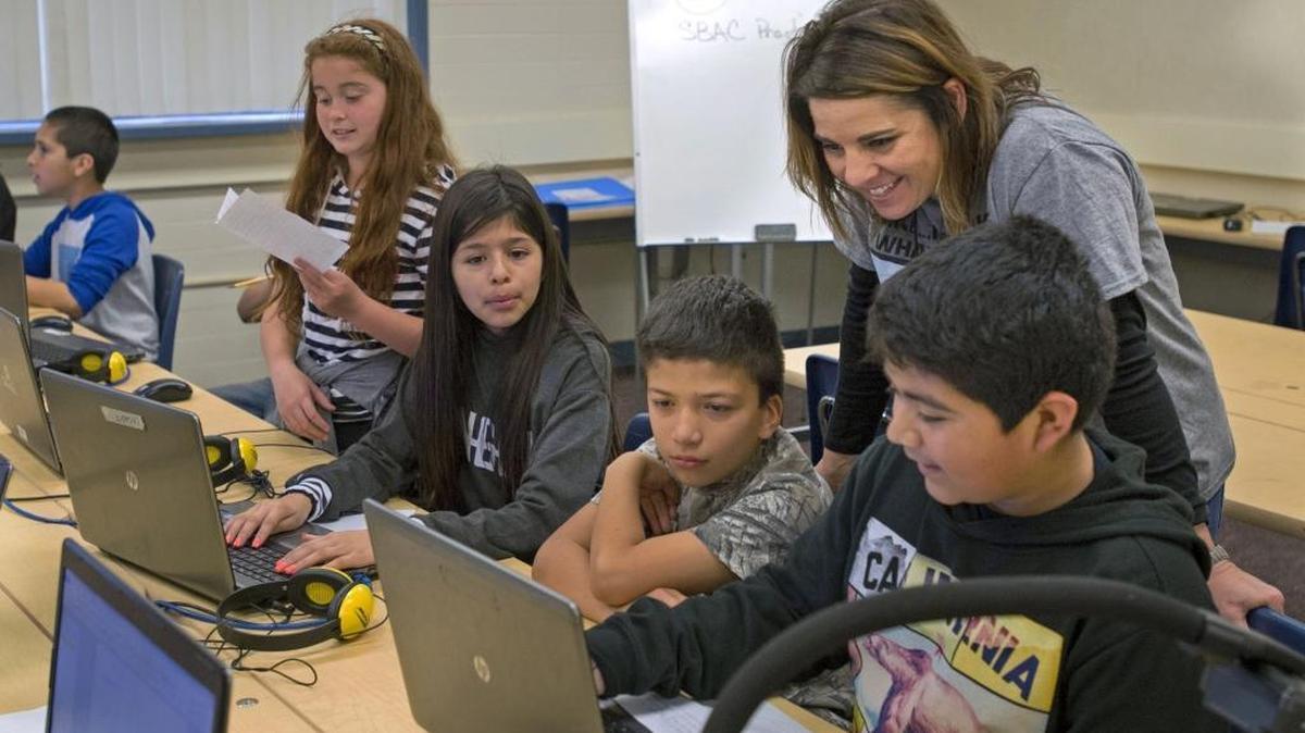 Fifth-grade teacher Lisa Santana works with her class in the computer lab, one of the facilities used for the summer enrichment program at Chrysler Elementary School in Modesto on Friday, March 4, 2016.
