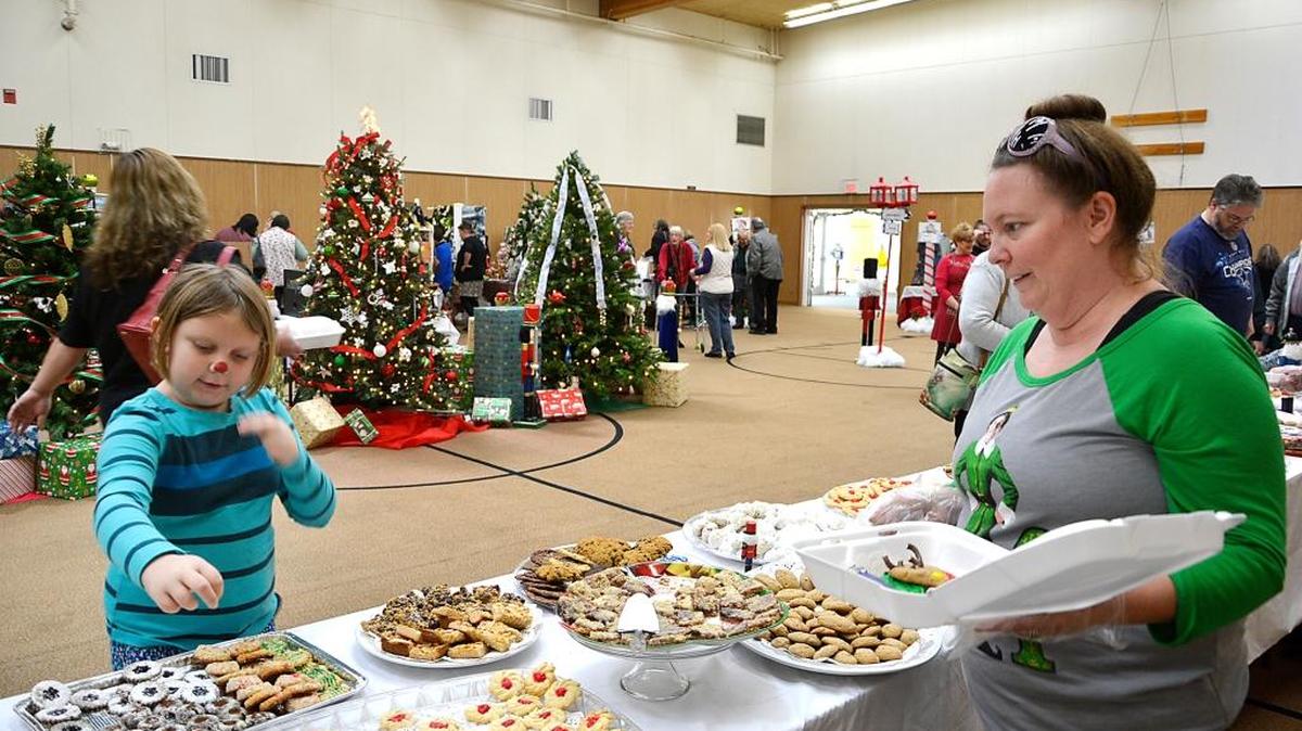 Danielle Verges and her daughter Alanna, 8, pick out cookies during St. Paul's Episcopal church’s cookie walk on Saturday. The event continues Sunday from 9 a.m. to 12. p.m. A baker's dozen is $7