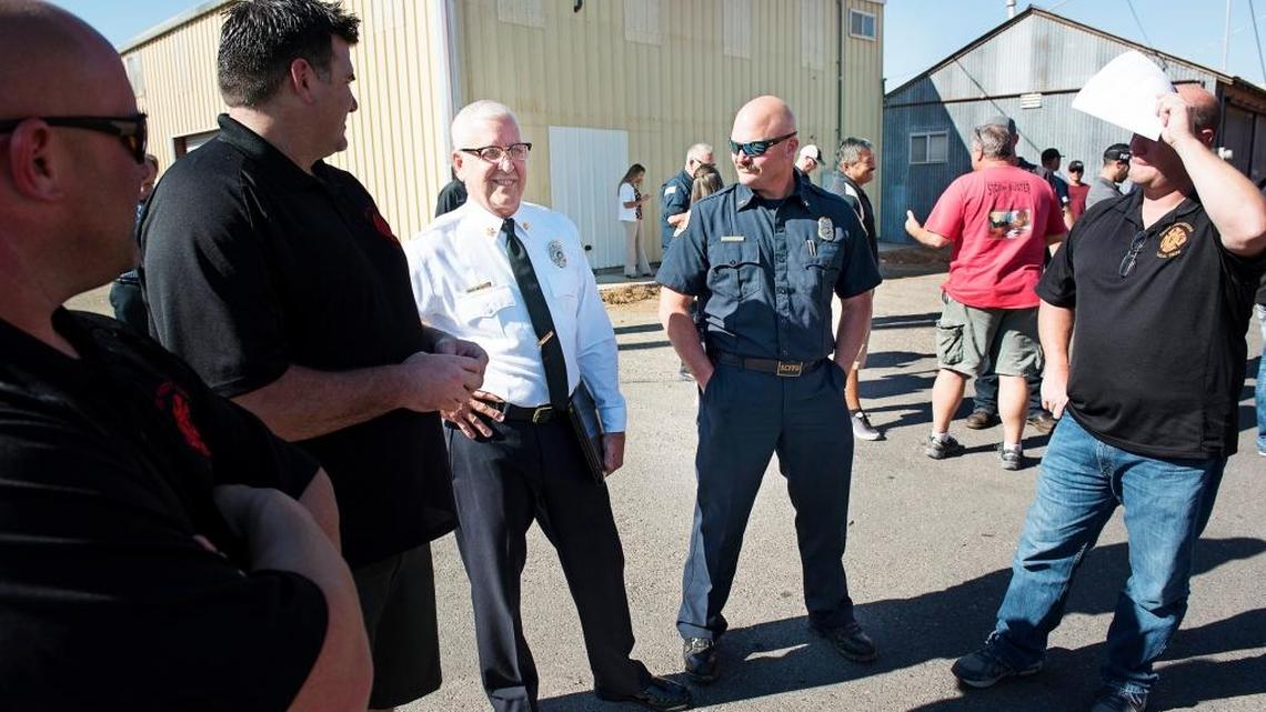 Stanislaus Consolidated Fire Chief Rick Weigele, third from left, talks with supporters during the closed-door session during a special meeting of the Stanislaus Consolidated Fire Protection District board in Riverbank, Calif., on Wednesday, Oct. 25, 2017.