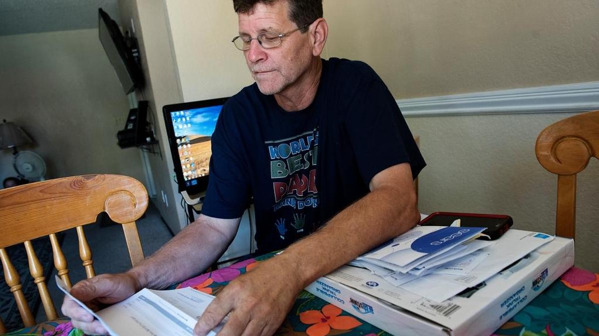 Bruce Pardini looks at his health insurance bill in his Modesto, Calif., home on Tuesday, July 11, 2017.