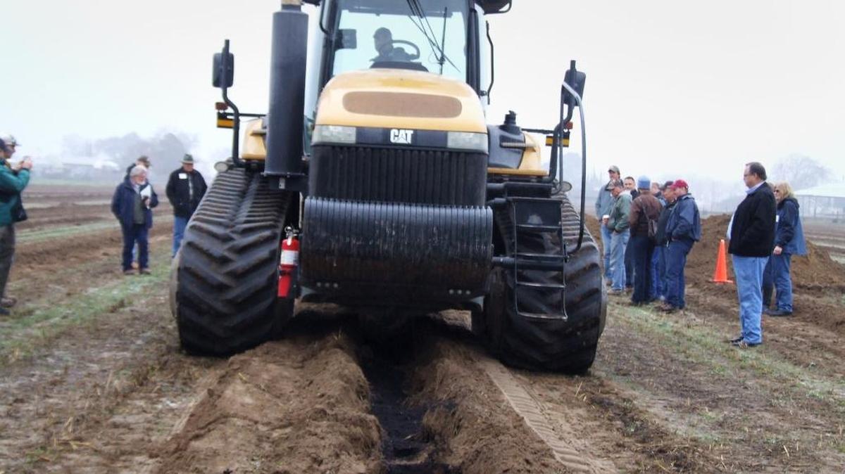 Farmers learn about compost, the black stuff being incorporated by a tractor, back in January at a farm just south of Turlock. Compost, made from landscape trimmings and other waste, helps soil retain moisture and nutrients.