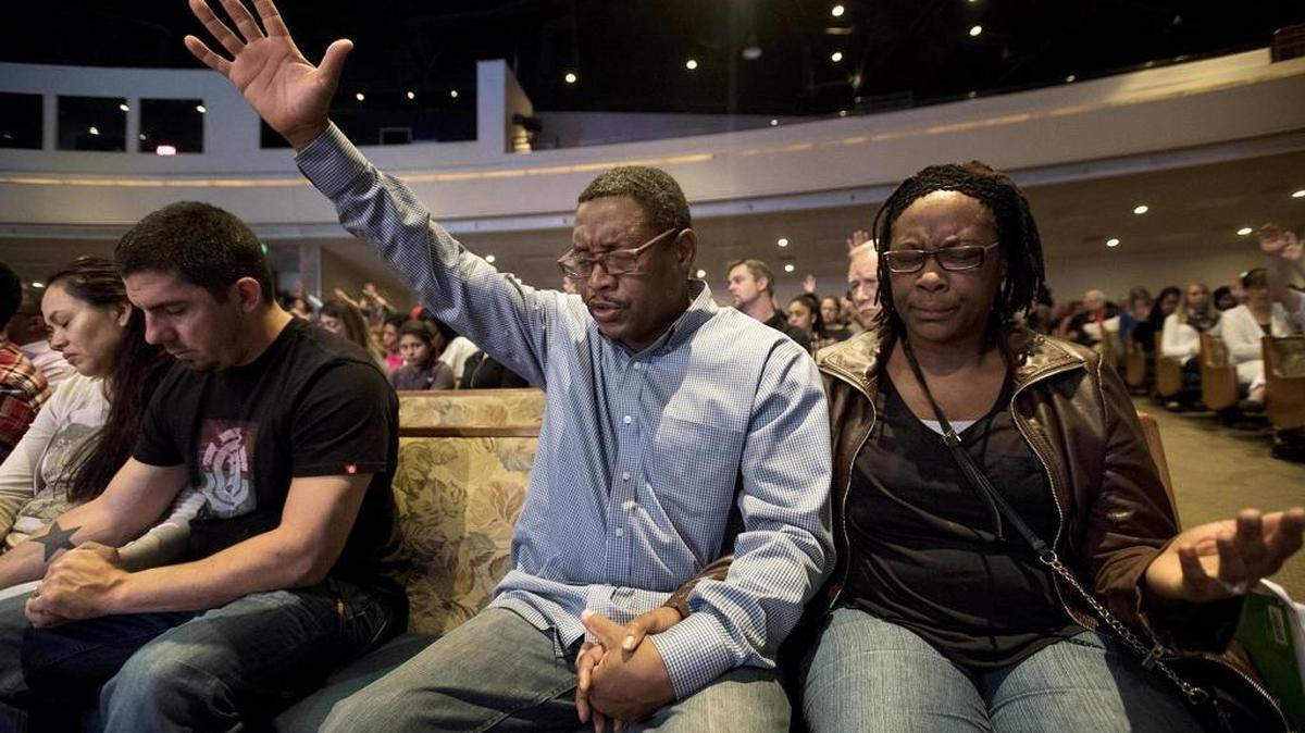 Larry and Alisa Twitty pray with Pastor Deborah Berteau as the Modesto congregation at The House gathers Monday to honor area law enforcement.