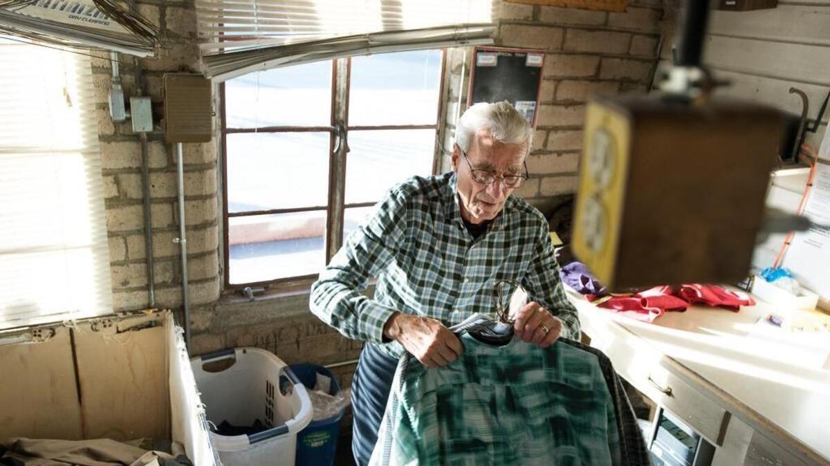 Carl Gagliardi tags shirts for cleaning at De Luxe Cleaners on McHenry Avenue in Modesto, Calif., on Tuesday, Dec. 27, 2016. The family is closing the business after 81 years.