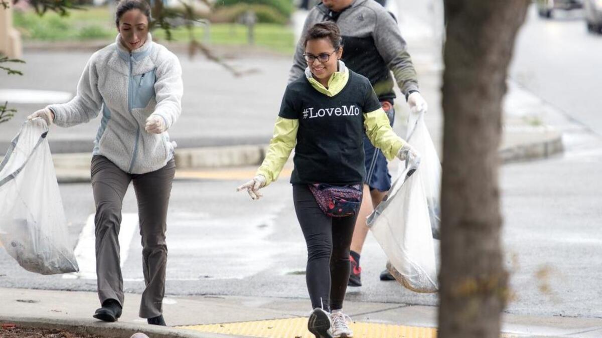 Volunteers Aracelly Inga, middle, Bronco Badel, left, and Raphael Pabalan pick up trash along McHenry Avenue as part of Love Modesto in Modesto, Calif., on Saturday, April 8, 2017.
