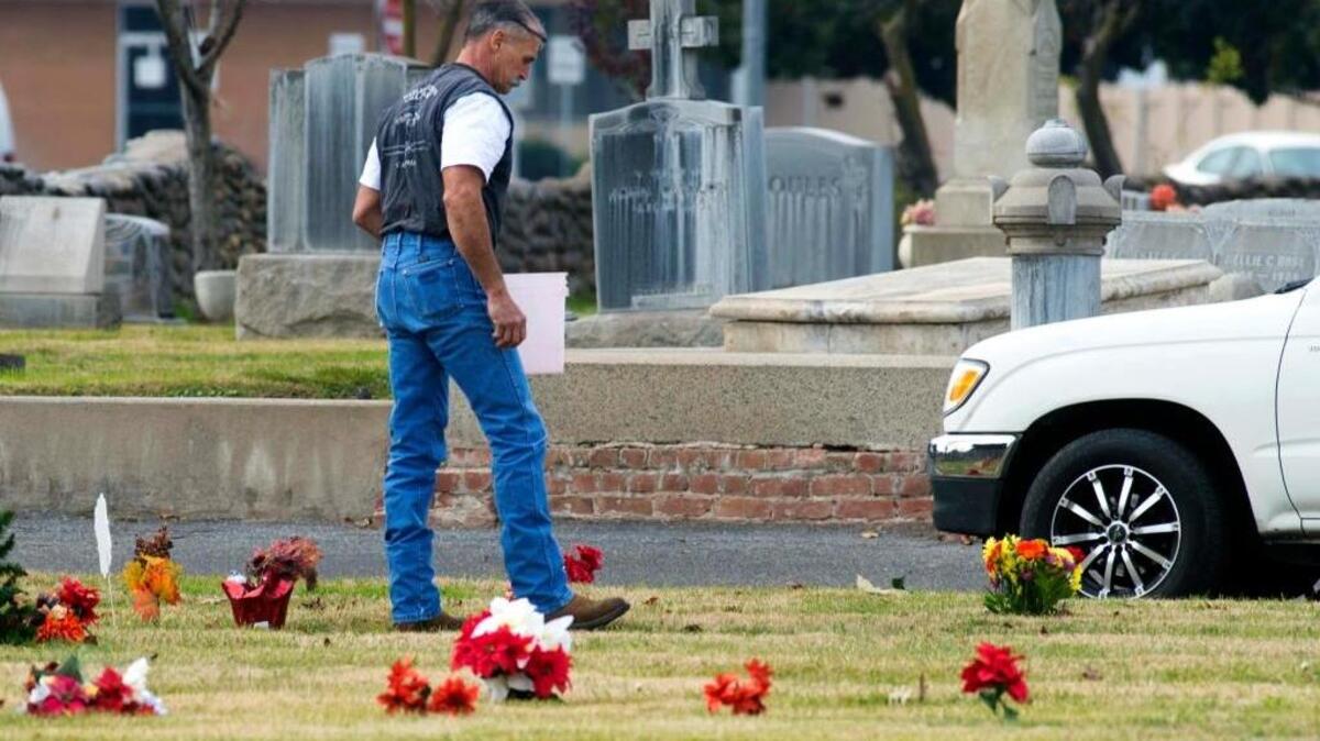 A Modesto resident pays his respects to deceased family members at St. Stanislaus Cemetery in Modesto on Sunday, Dec. 27, 2015.