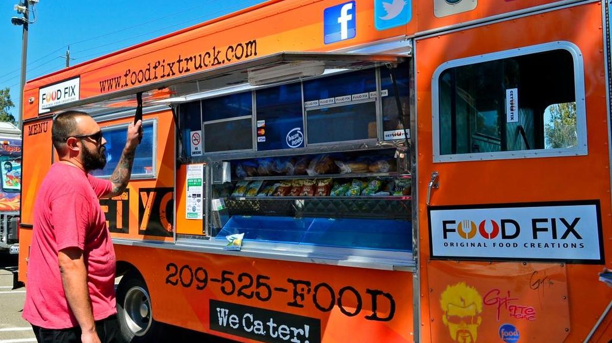 Hank Olson prepares his food truck, Food Fix, for a food truck gathering at The Post Restaurant in Modesto on Saturday, Aug. 13, 2016.