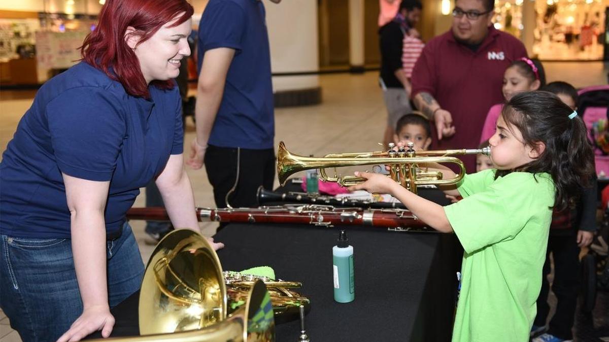 Franki Martinez, 7, tries out a trumpet under the supervision of Erica Wills on Thursday afternoon, Feb. 18, 2016, at Vintage Faire Mall in Modesto during the Modesto Symphony Orchestra’s Instrument Petting Zoo.