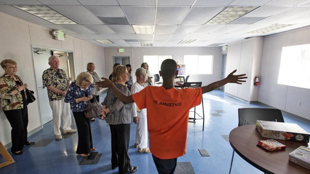 Junior staff member Maurice Williams welcomes guests into the new Boys and Girls Club of Stanislaus County at the King-Kennedy Memorial Center in Modesto, Calif., on Friday, October 7, 2016. The club is still seeking donations to furnish the modular building.