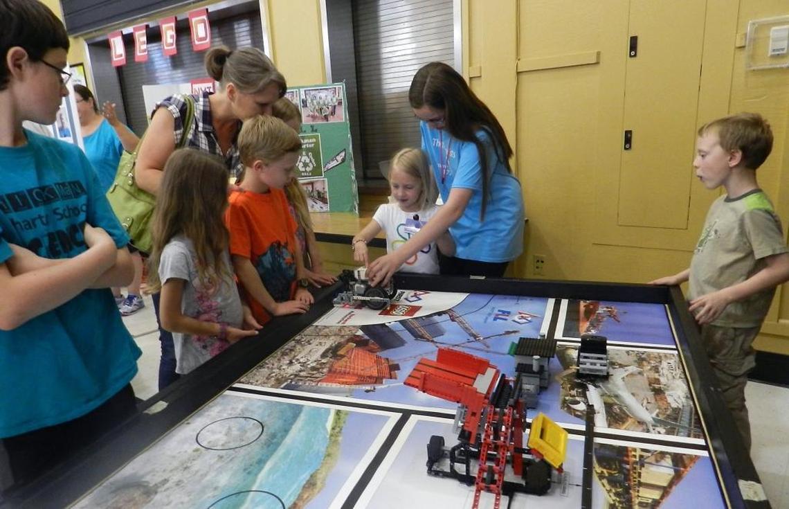 Seventh-grader Katie Osterhout helps youngsters run Lego robots at the Hickman Charter School STEM Maker Faire.